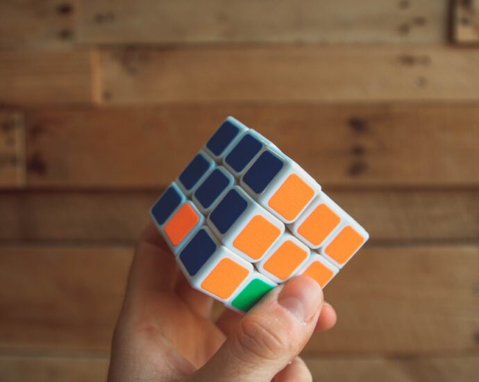 person holding 3x3 Rubik's Cube